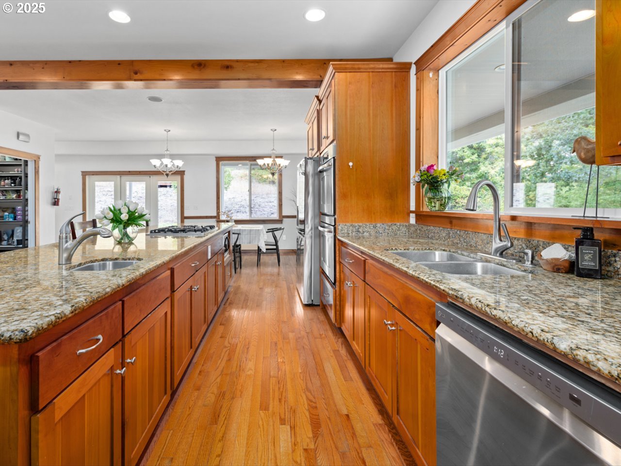 33678 Marys River Estates Road Philomath, OR 97370 - Photo 26 of 48 a view of a kitchen with kitchen island granite countertop a large window a sink and counter space