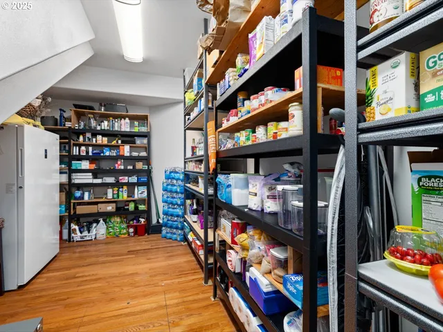 a view of a kitchen with wooden floor and a kitchen