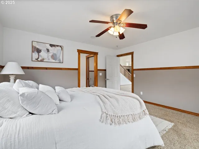 a bathroom with a granite countertop sink and a large mirror