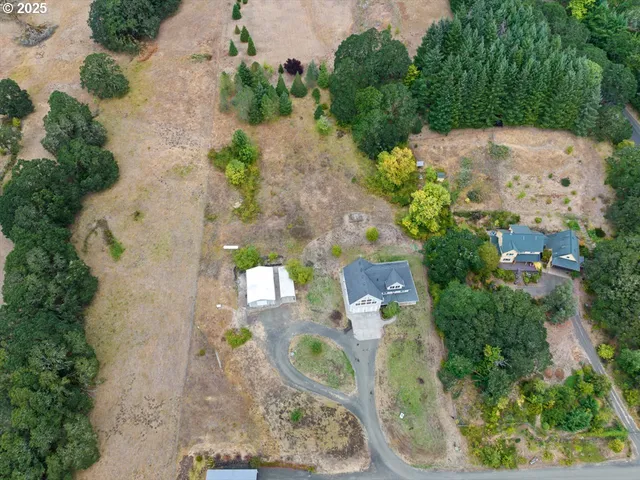 an aerial view of a house with outdoor space