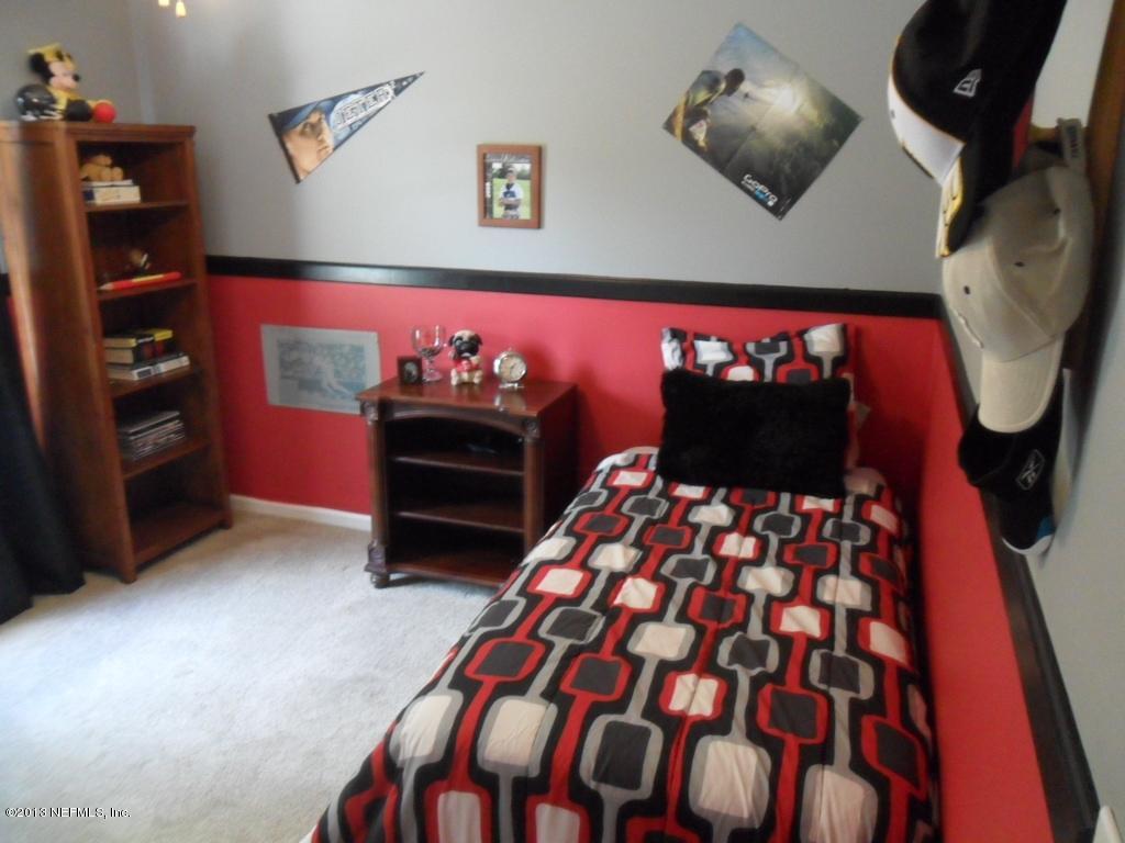 716 South Lilac Loop St. Johns, FL 32259 - Photo 12 of 22 a bedroom with a bed and a television