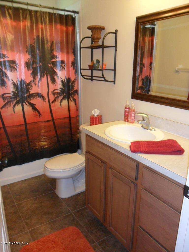 716 South Lilac Loop St. Johns, FL 32259 - Photo 14 of 22 a bathroom with a toilet sink and mirror