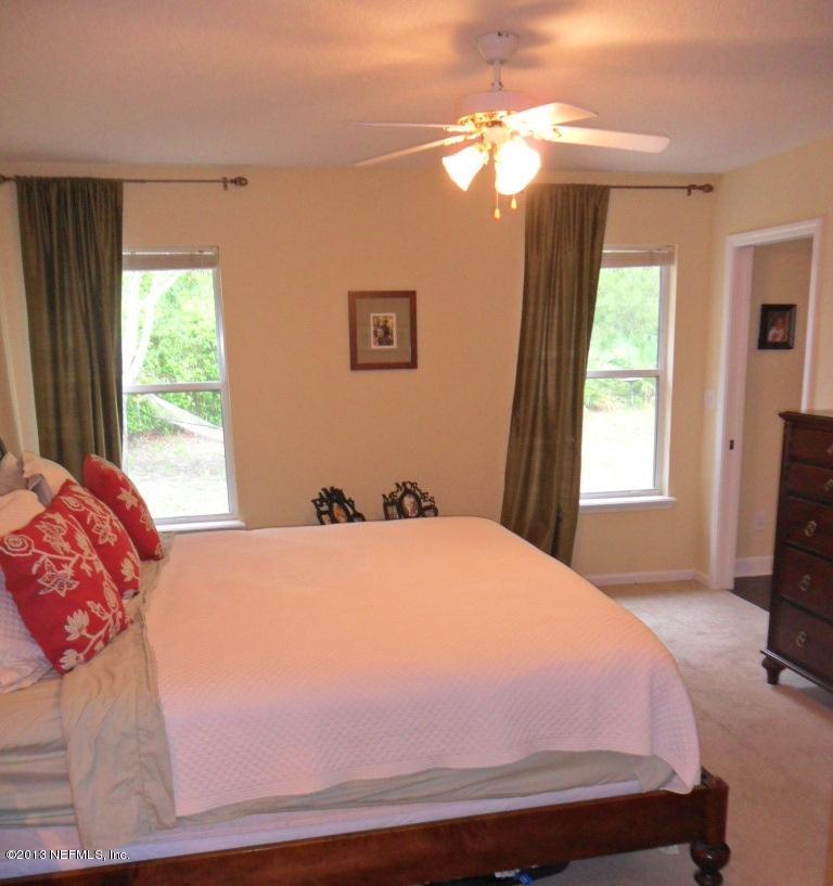 716 South Lilac Loop St. Johns, FL 32259 - Photo 19 of 22 a bedroom with a bed and a tv