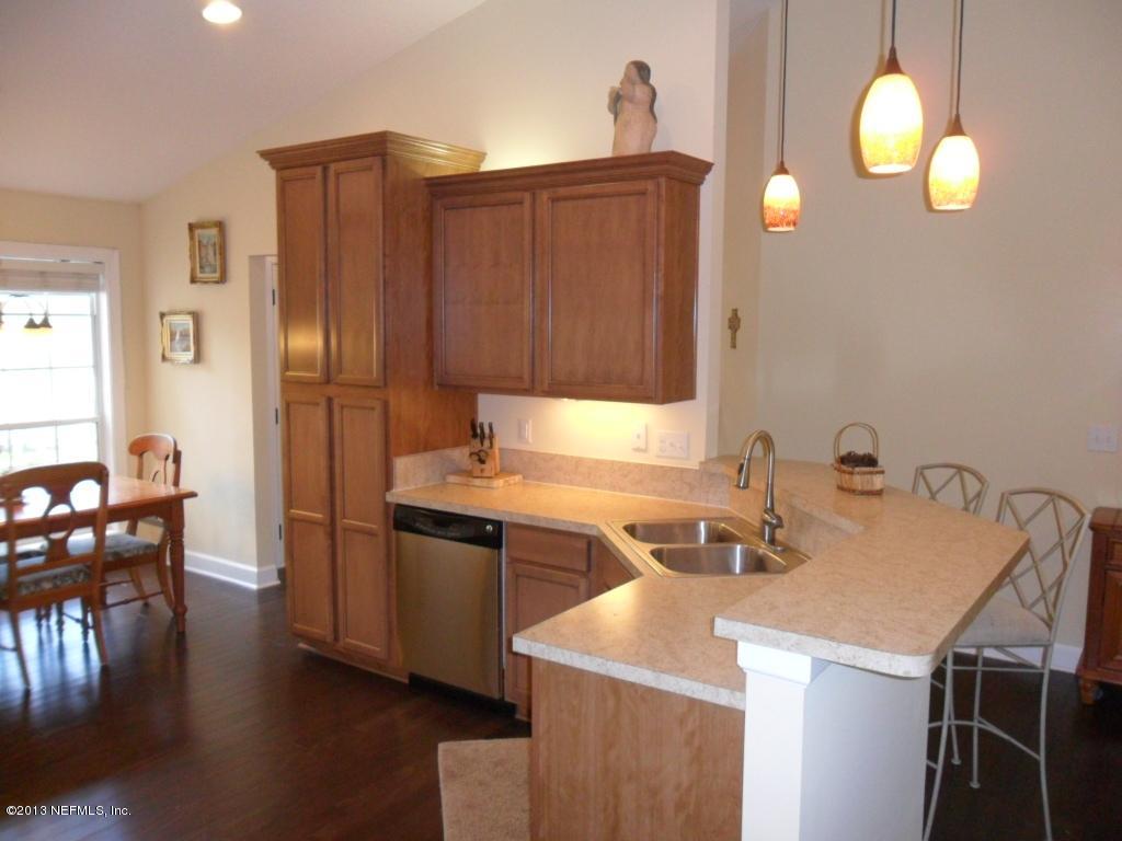 716 South Lilac Loop St. Johns, FL 32259 - Photo 7 of 22 a kitchen with a sink cabinets and wooden floor
