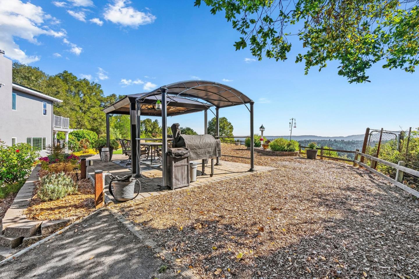 2500 Nelson Road Scotts Valley, CA 95066 - Photo 39 of 77 a view of a patio with a table and chairs under an umbrella