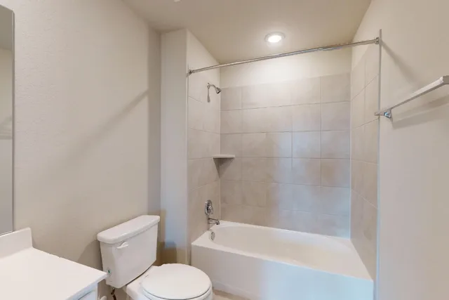 a bathroom with a toilet and a bath tub