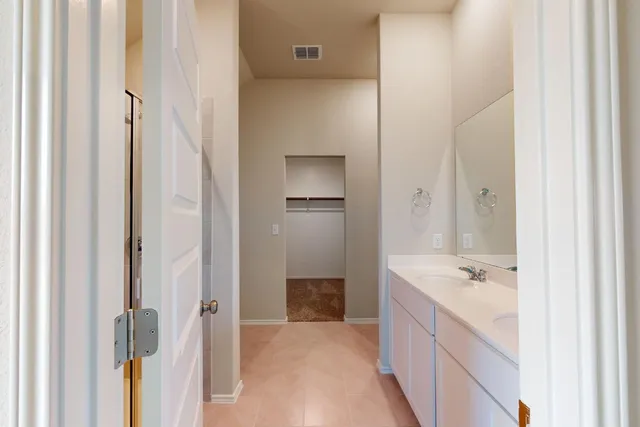 a bathroom with a bathtub sink and mirror
