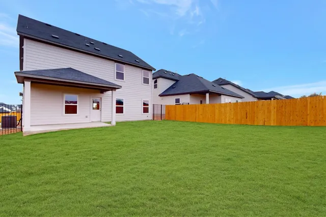 a front view of house with yard and outdoor seating