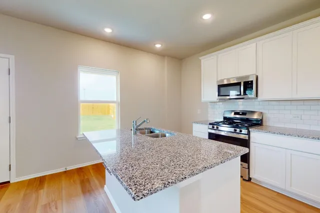 a kitchen with sink and microwave