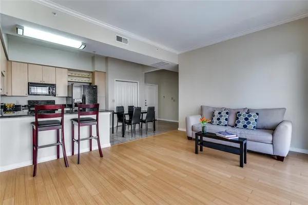a living room with furniture and wooden floor