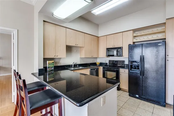 a kitchen with a stove a refrigerator and a sink