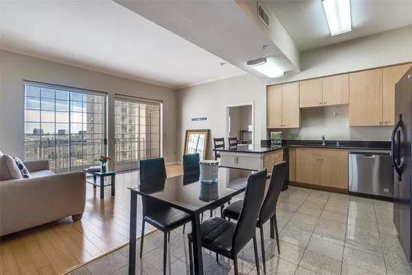 a dining room with furniture and wooden floor