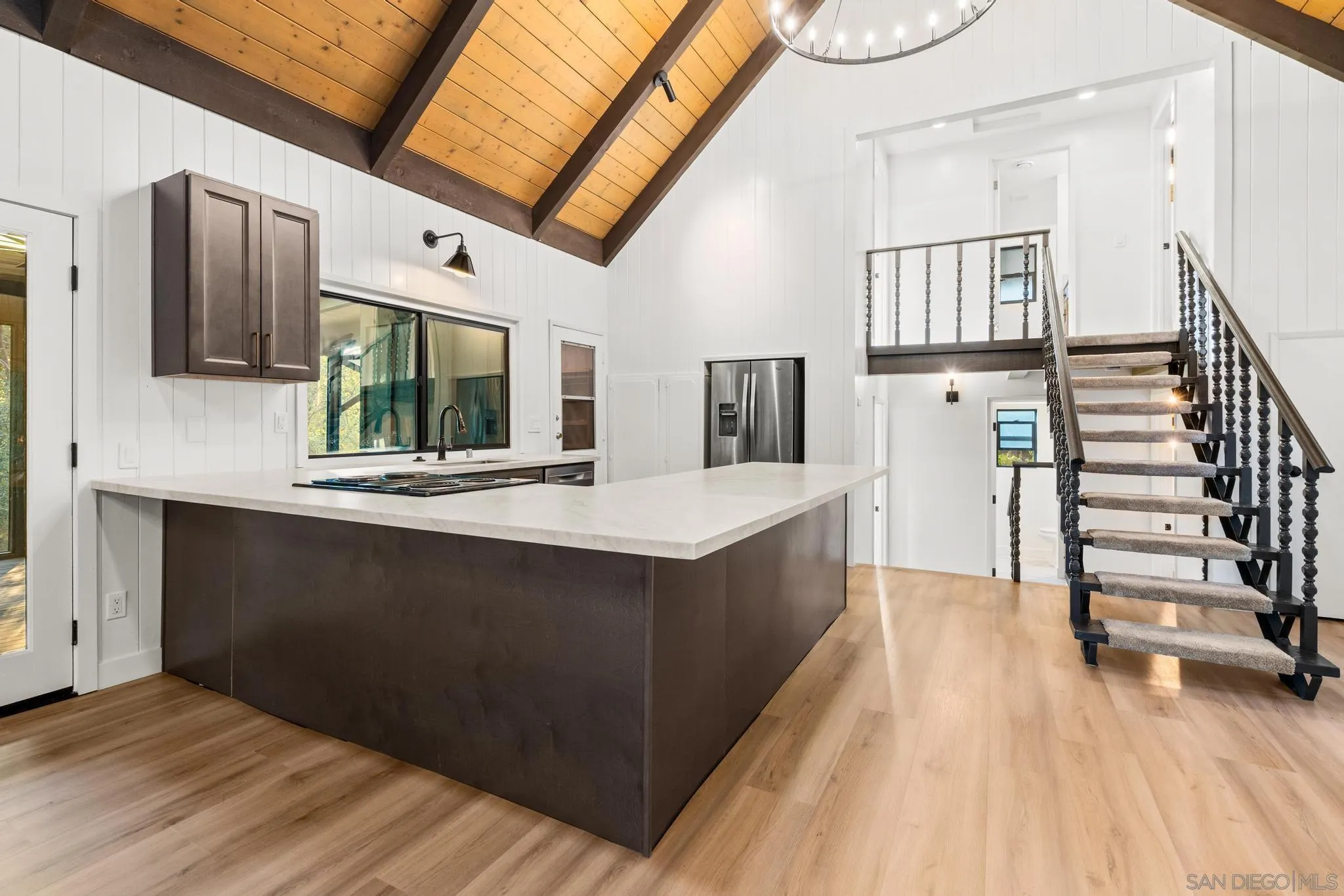 8648 Valley View Trail Pine Valley, CA 91962 - Photo 11 of 50 a kitchen with stainless steel appliances kitchen island granite countertop a sink and a wooden floor