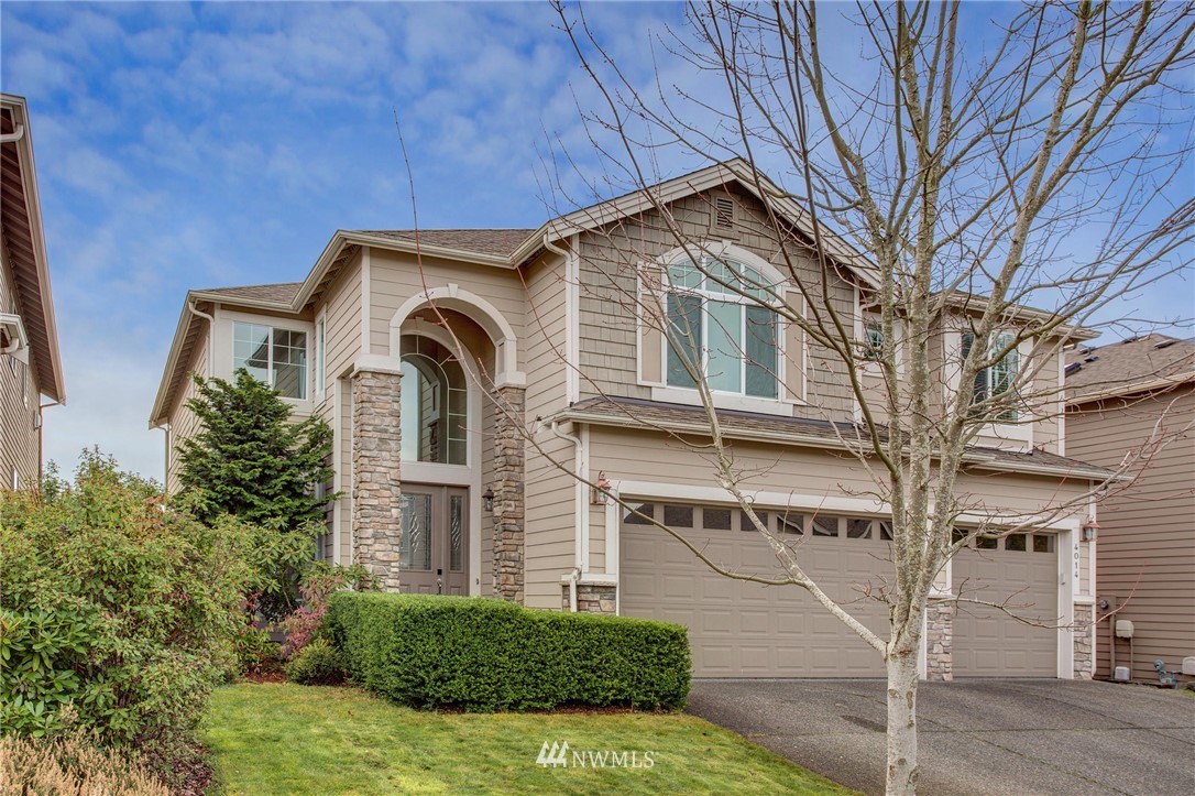 4014 215th Street Southeast Bothell, WA 98021 - Photo 1 of 25 a front view of a house with garden
