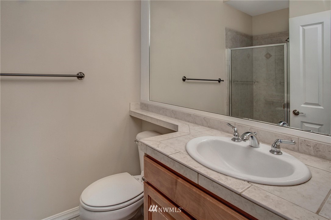 4014 215th Street Southeast Bothell, WA 98021 - Photo 12 of 25 a bathroom with a sink toilet and a mirror