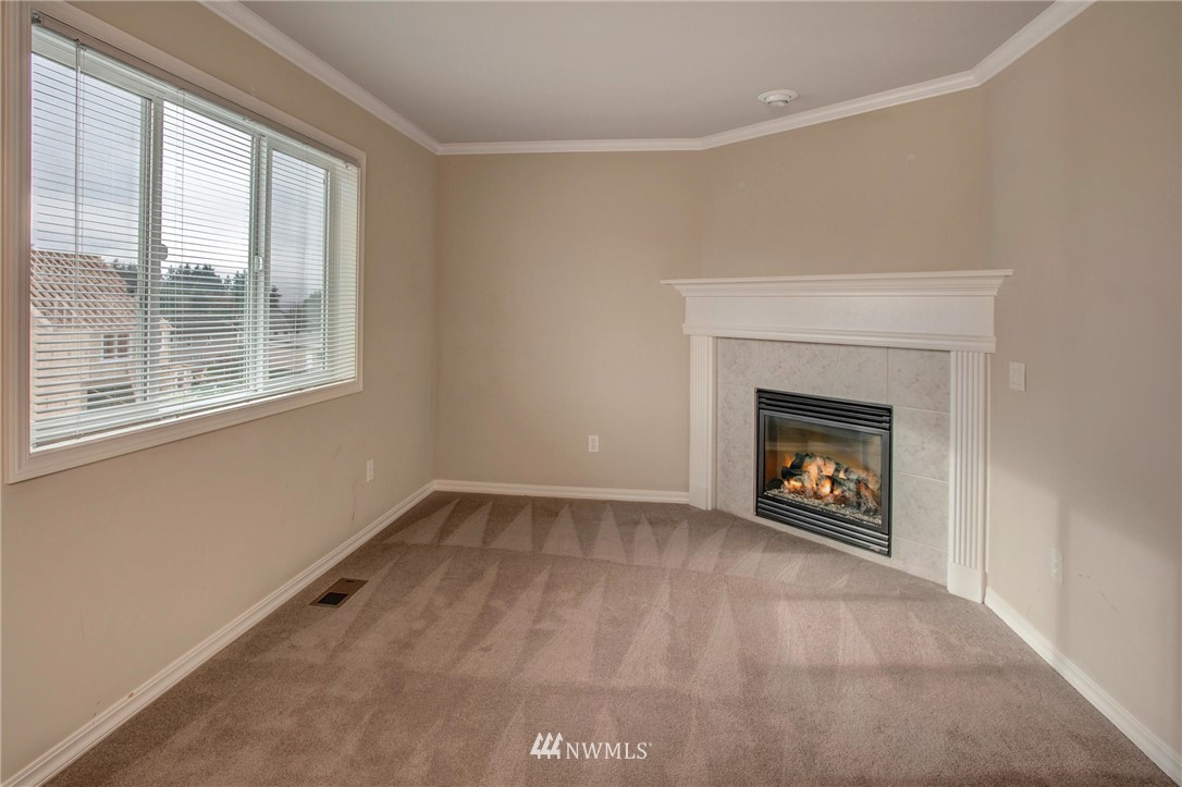 4014 215th Street Southeast Bothell, WA 98021 - Photo 15 of 25 a view of an empty room with a window and a fireplace