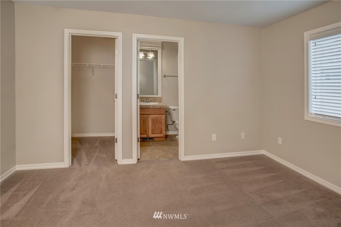4014 215th Street Southeast Bothell, WA 98021 - Photo 19 of 25 an empty room with windows and closet