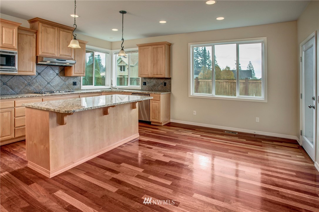 4014 215th Street Southeast Bothell, WA 98021 - Photo 8 of 25 a kitchen with stainless steel appliances granite countertop a stove a sink and a refrigerator