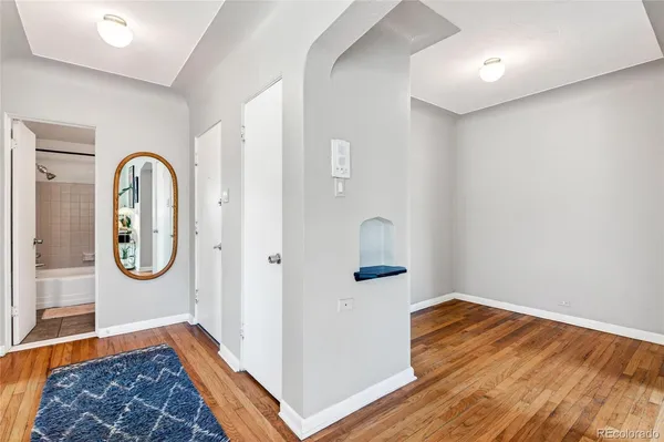 a view of a room with wooden floor and window