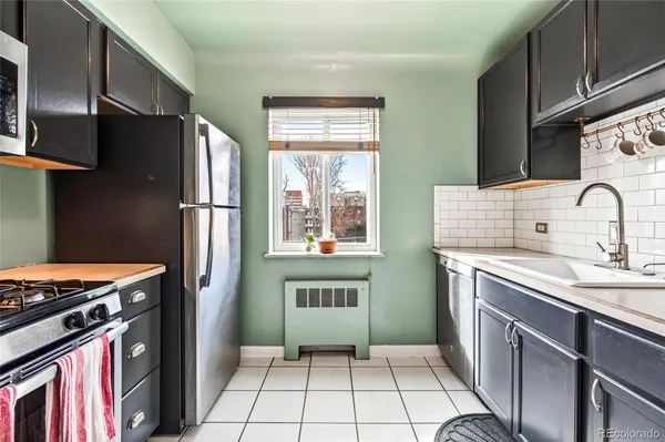 a kitchen with a refrigerator sink and stove