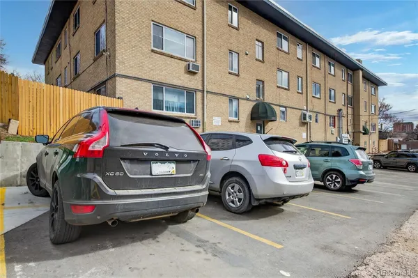 a view of a car is parked in front of a building