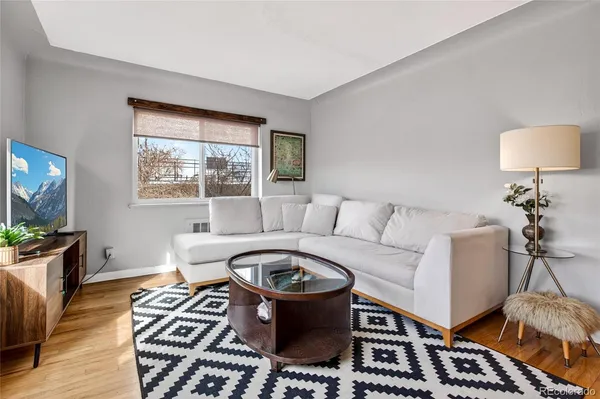 a living room with furniture and a rug