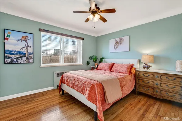 a bedroom with a bed and a painting on the wall