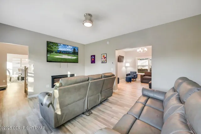 a view of a livingroom with wooden floor and a fireplace
