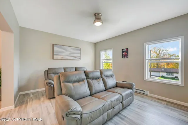 a view of staircase with white walls and a fan