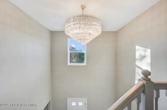 a bedroom with a large bed and a chandelier