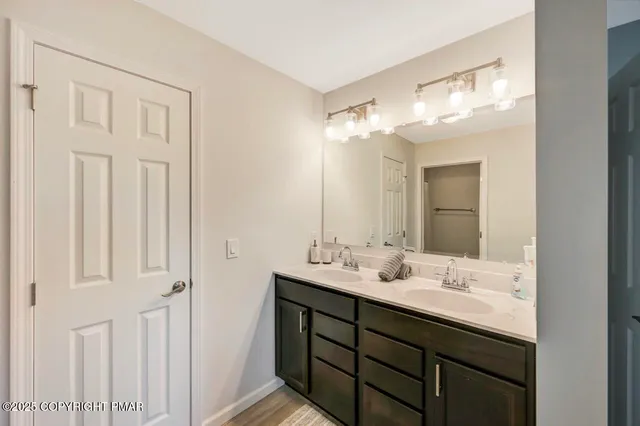a bathroom with a tub sink and mirror