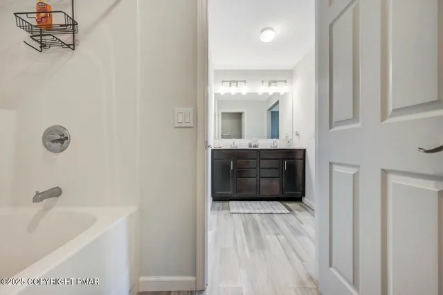 a bedroom with a bed and a wooden floor