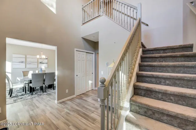 a view of entryway and hall with wooden floor