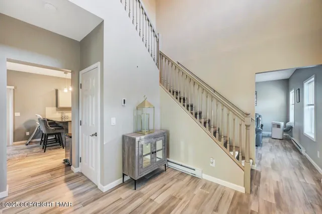 a view of entryway and hall with wooden floor