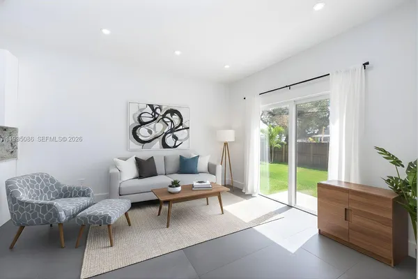 a living room with furniture and a large window