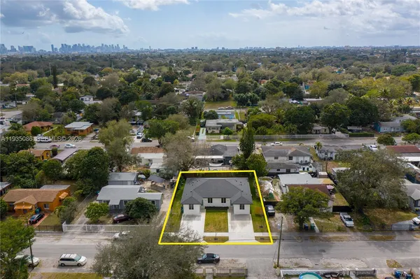 an aerial view of residential houses with outdoor space