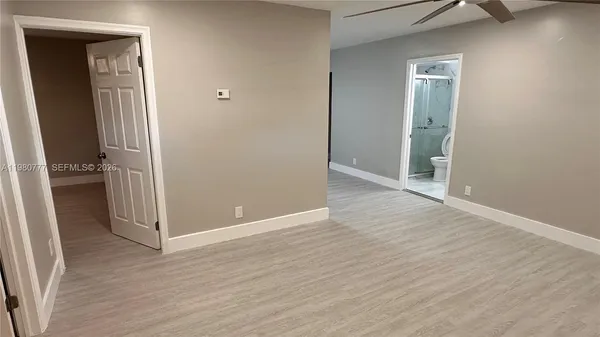 an empty room with wooden floor and closet