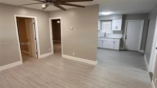 a view of a kitchen with a sink and a refrigerator