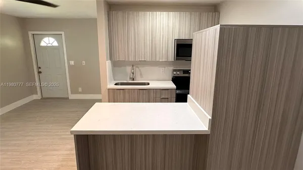 a kitchen with stainless steel appliances a refrigerator and a stove top oven