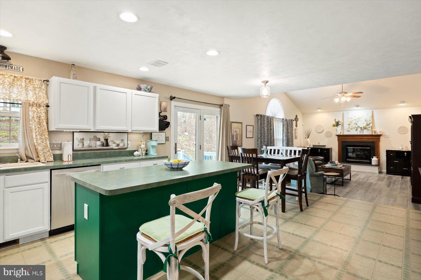 8472 Colfax Drive King George, VA 22485 - Photo 14 of 62 a kitchen with a dining table chairs sink and cabinets