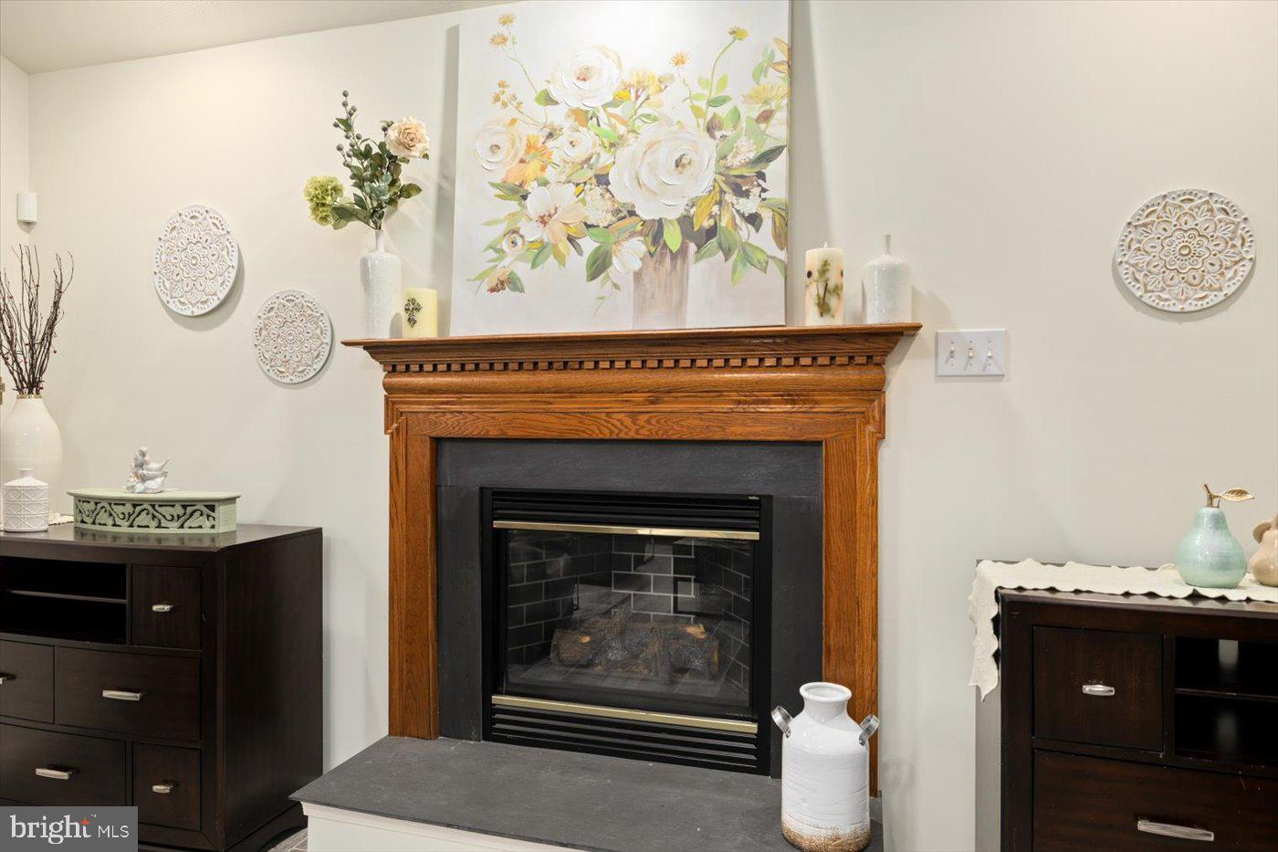 8472 Colfax Drive King George, VA 22485 - Photo 22 of 62 a living room with a fireplace and a table