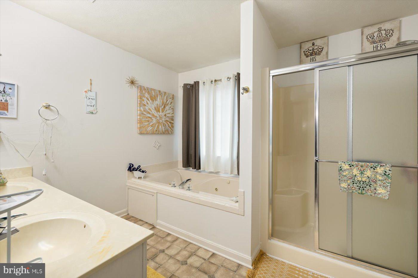 8472 Colfax Drive King George, VA 22485 - Photo 32 of 62 a bathroom with a tub sink and mirror