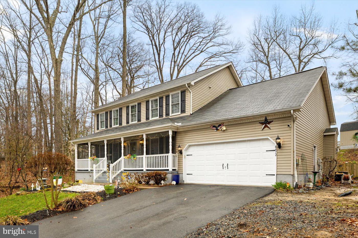 8472 Colfax Drive King George, VA 22485 - Photo 58 of 62 a front view of a house with a yard and garage
