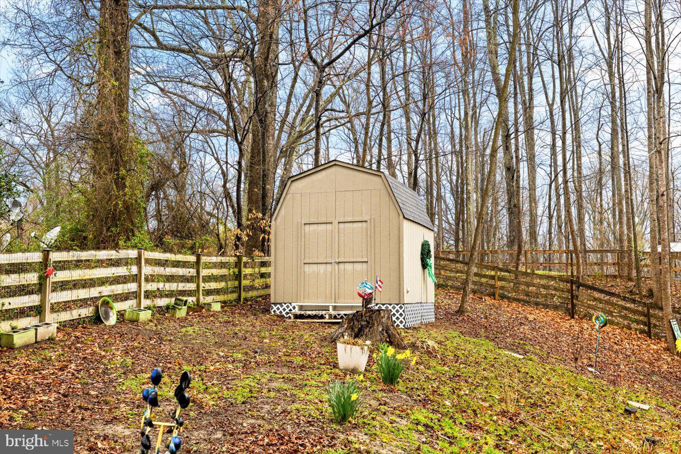 8472 Colfax Drive King George, VA 22485 - Photo 59 of 62 a view of backyard with large trees and wooden fence