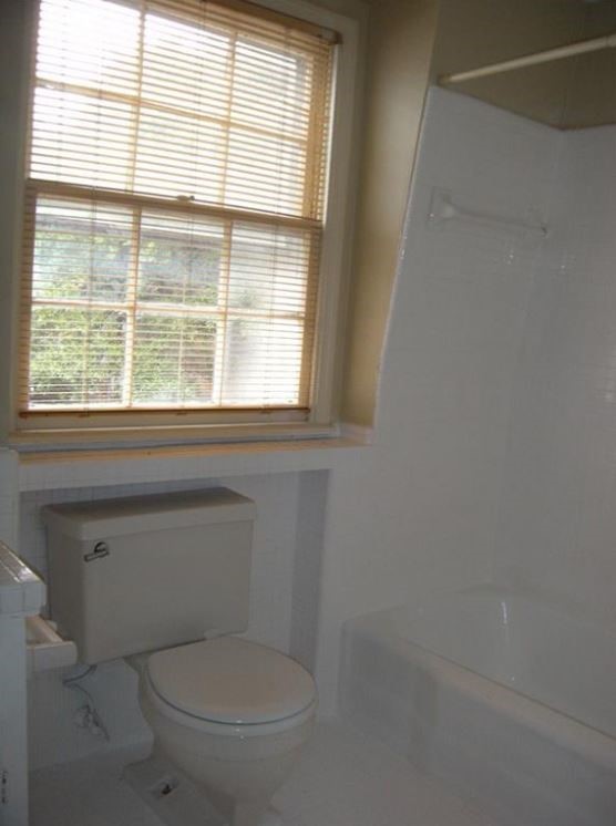 2704 San Pedro Street, Unit 2 Austin, TX 78705 - Photo 19 of 23 a white toilet sitting in front of a window