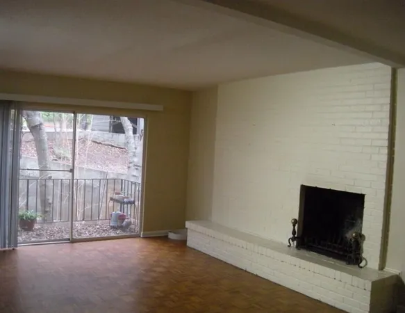 a view of empty room with a fireplace