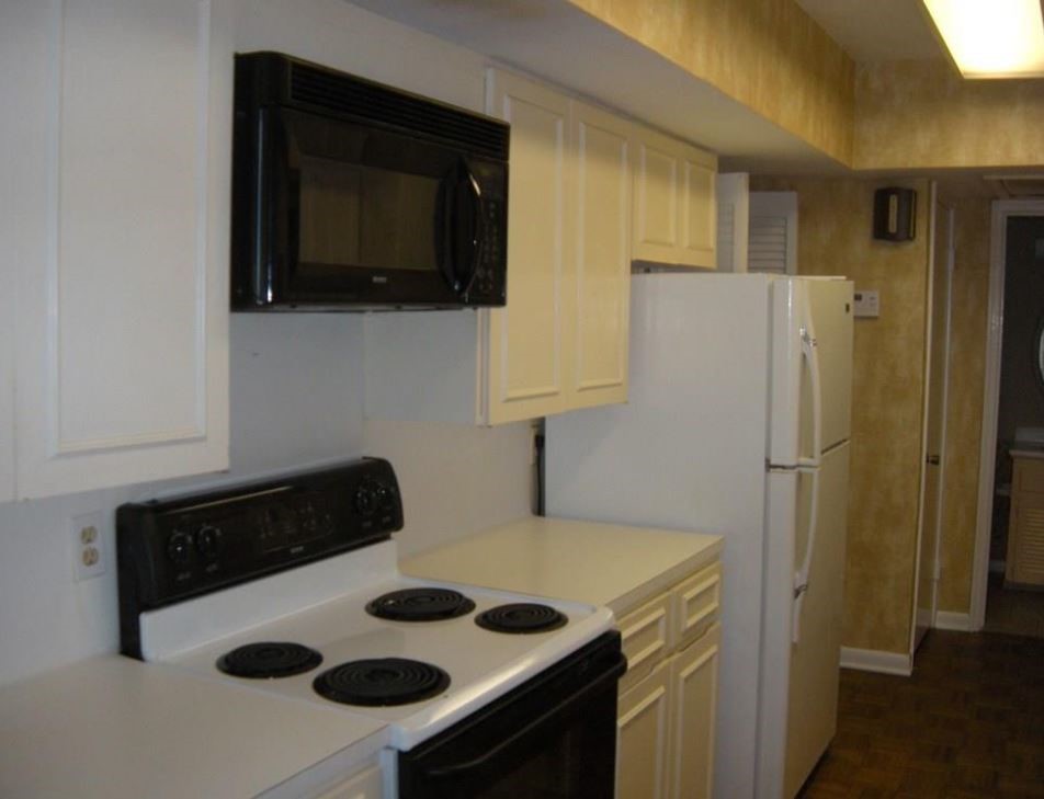 2704 San Pedro Street, Unit 2 Austin, TX 78705 - Photo 9 of 23 a kitchen with a refrigerator and a stove top oven