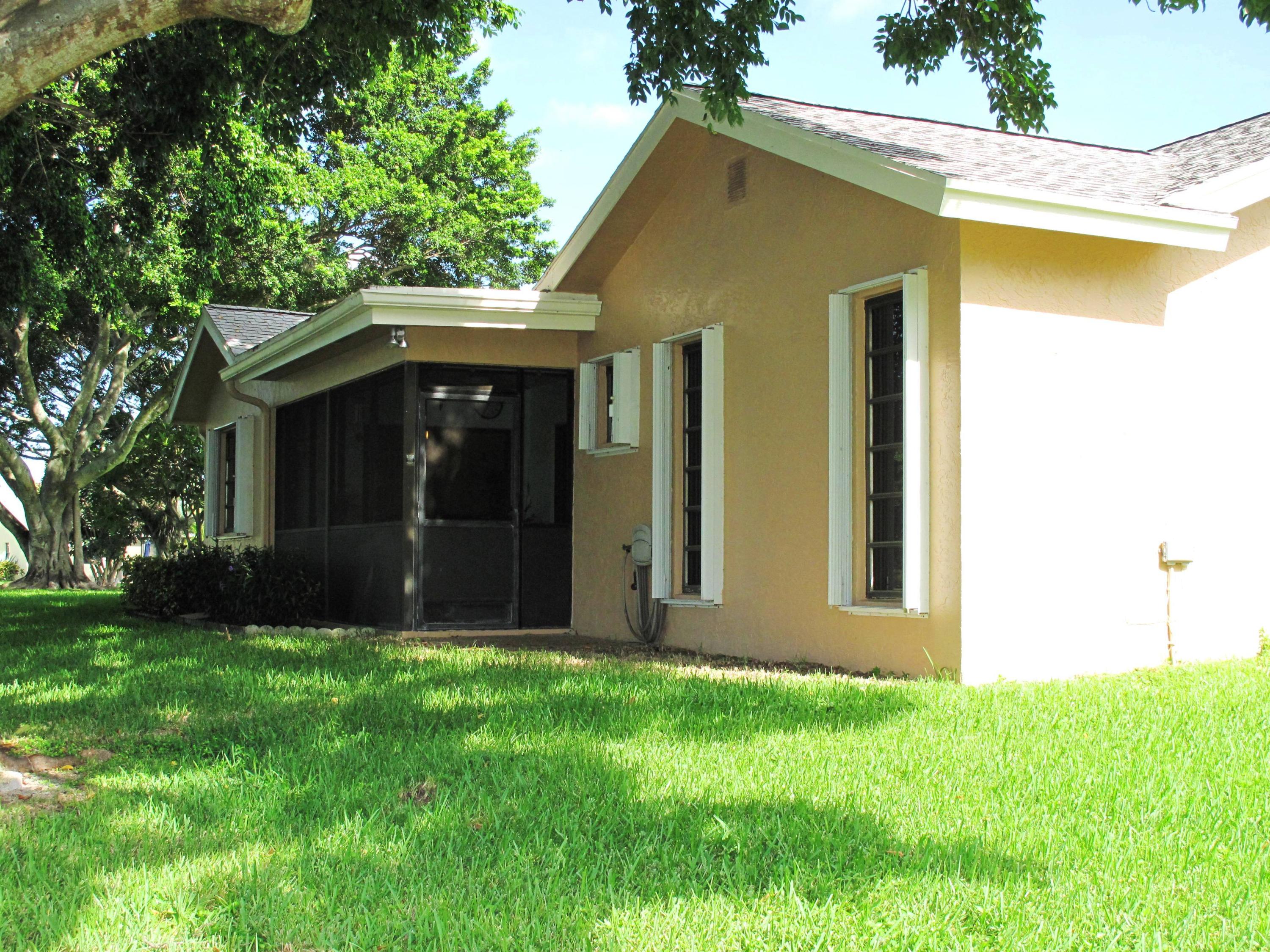 10740 180th Place South Boca Raton, FL 33498 - Photo 28 of 59 Back view of home with large shade tree