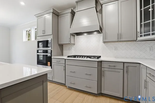 a kitchen with cabinets and appliances