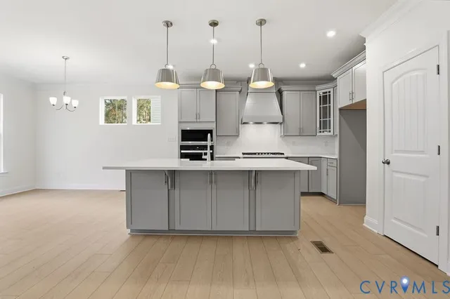 a kitchen with kitchen island a sink stainless steel appliances and cabinets